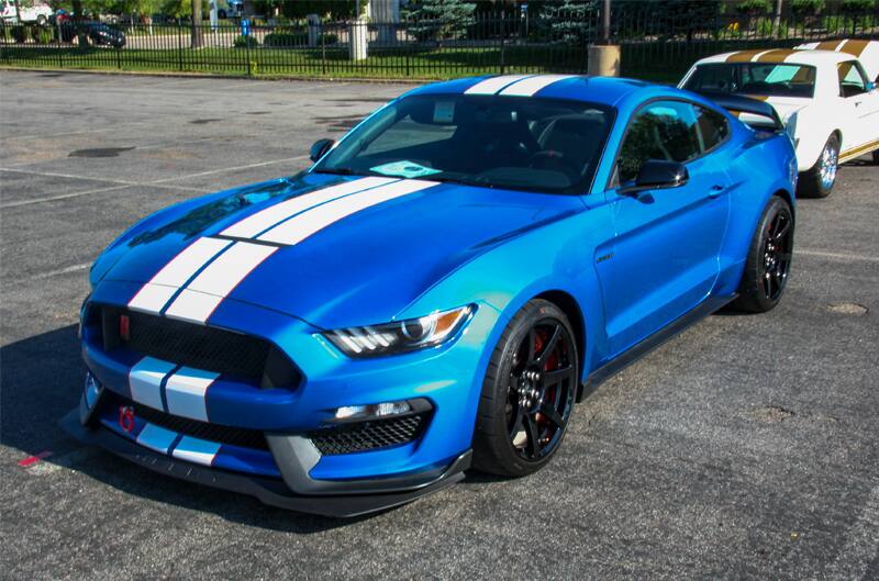 A blue and white Mustang on display