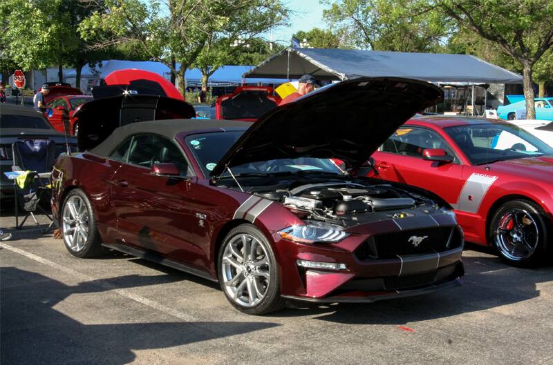 A maroon Mustang convertible on display