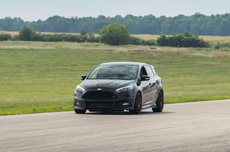 A front side view of a Ford Fiesta ST driving the track