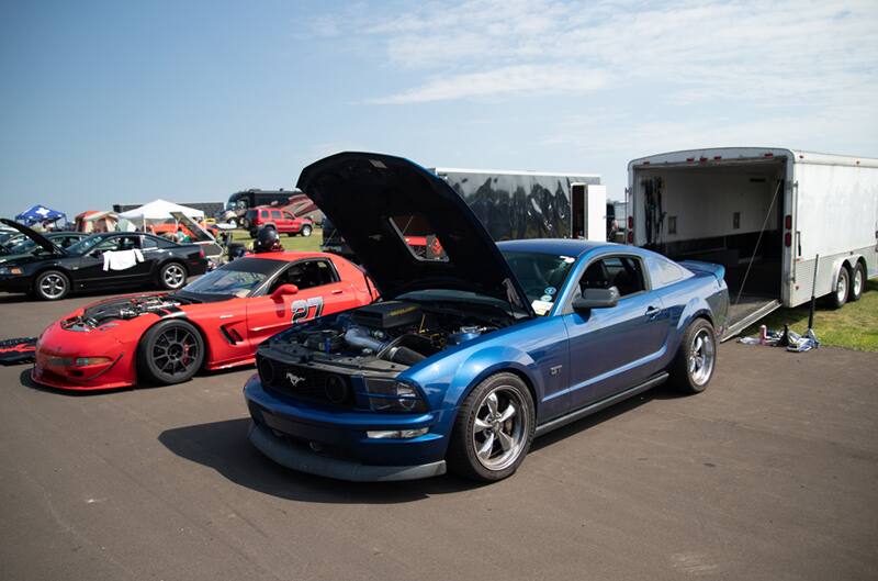 A front side view of a blue Mustang on display