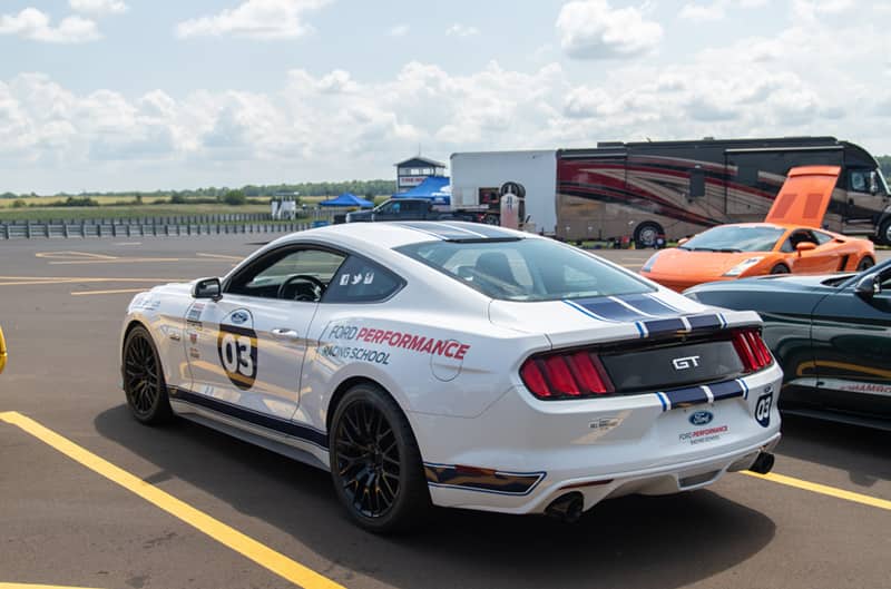 A rear side view of a Ford Performance Racing School Mustang on display