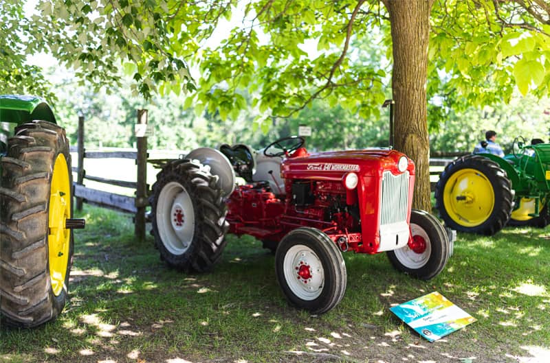 A red Ford tractor on display