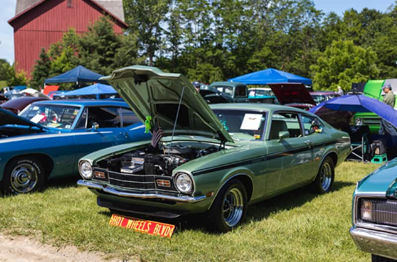 A green vehicle on display with hood up