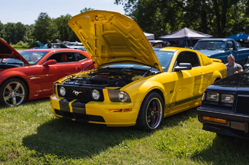 A front side view of a yellow Mustang on display