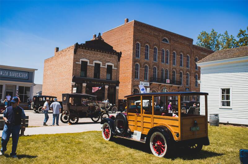 A rear side view of a classic vehicle on display