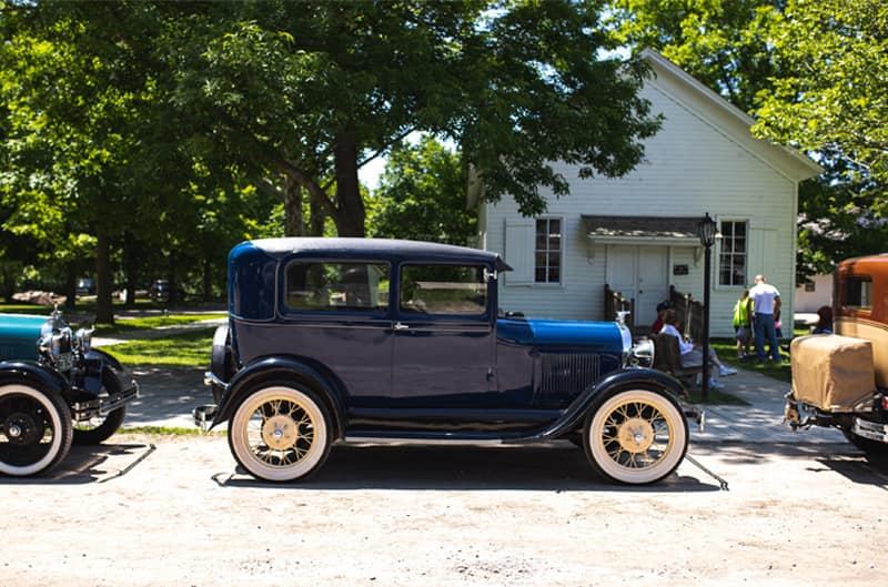 A side view of a classic blue vehicle on display