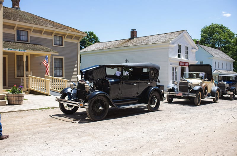 A front side view of a classic black vehicle on display