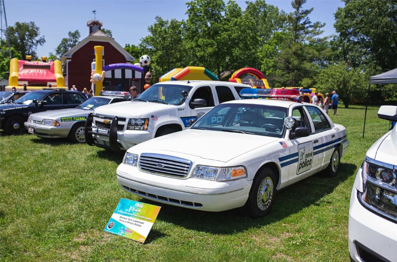 A lineup of police vehicles on display