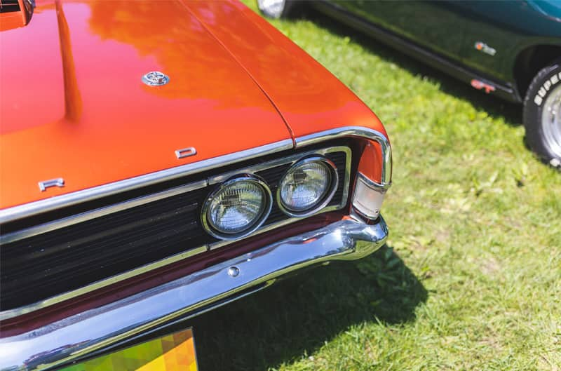 A closeup of the front end of a classic Ford vehicle