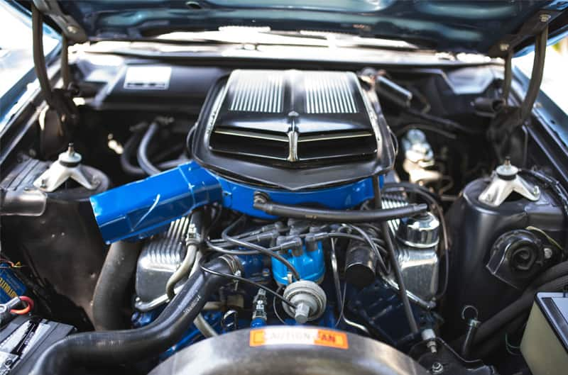 A closeup of the engine inside a classic vehicle