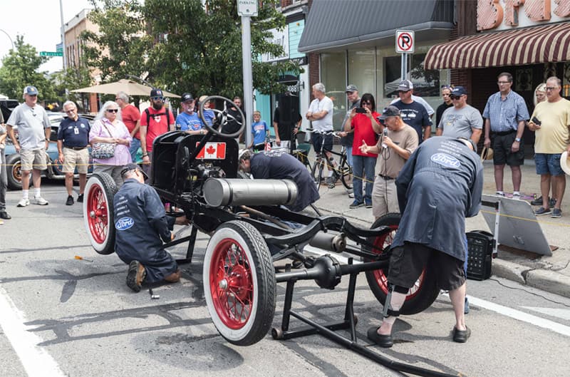 A small group assembling a Model T