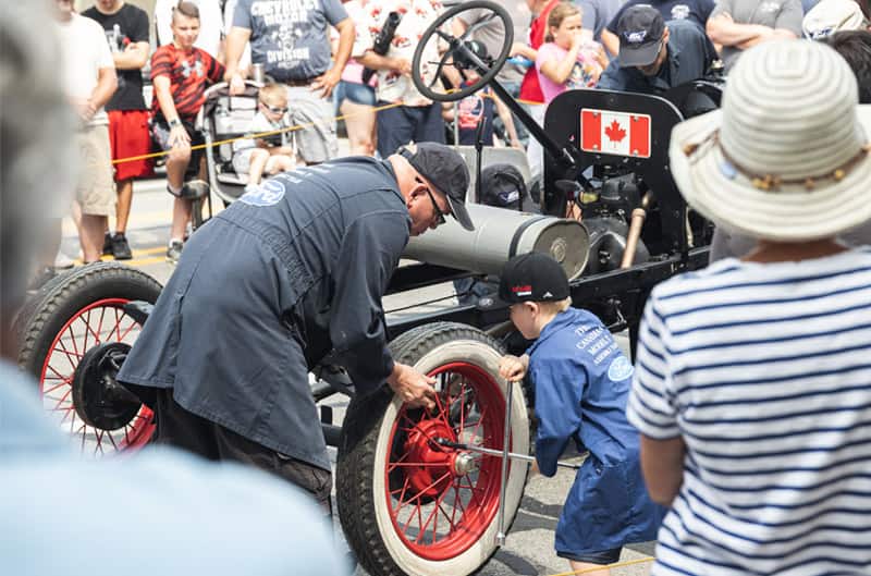 Two people assembling a Model T