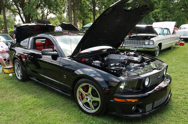 A front side view of black Mustang on display