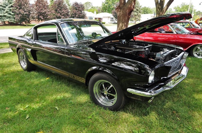 A classic Mustang GT350 on display with the hood up