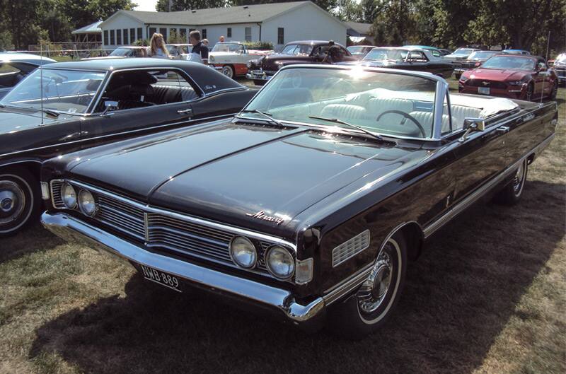 Front of a black Mercury convertible parked on the grass