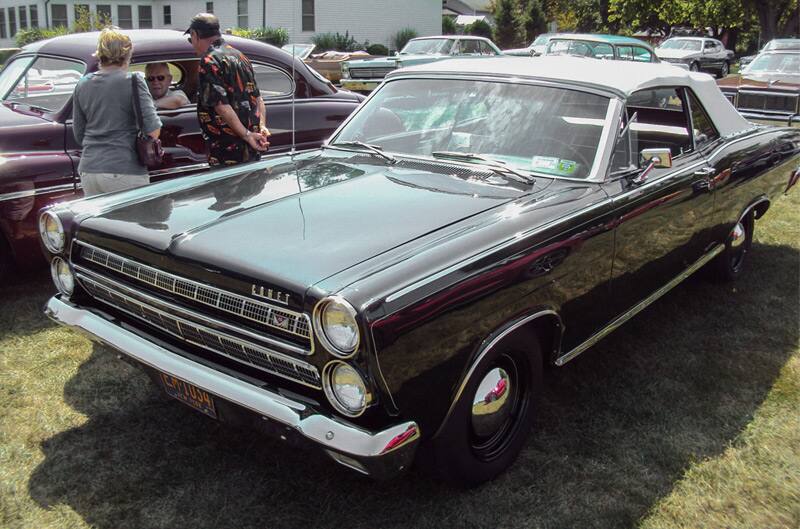 Front profile of a black Comet parked on the grass