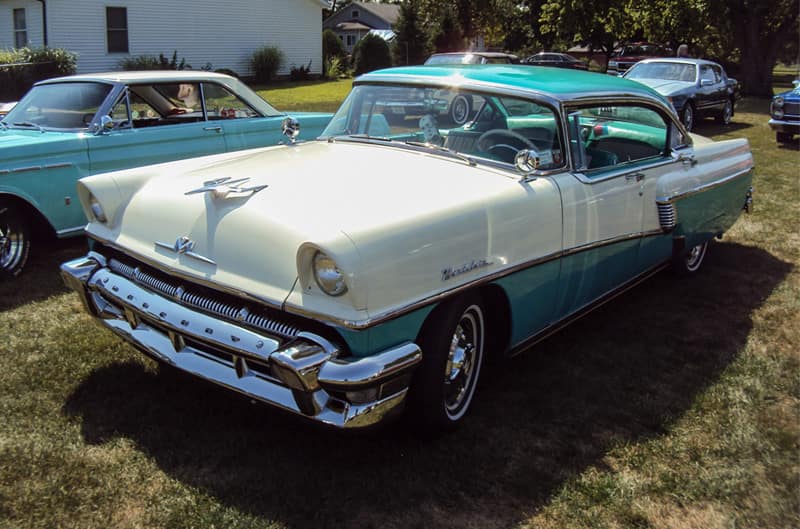 Front profile of a white and green Pontiac Star Chief parked on the grass