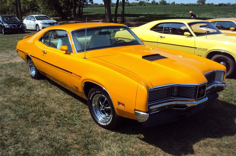 Front profile of a yellow Cyclone parked on the grass