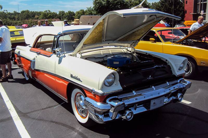 Front of a white and orange Pontiac Star Chief with hood open in the parking lot