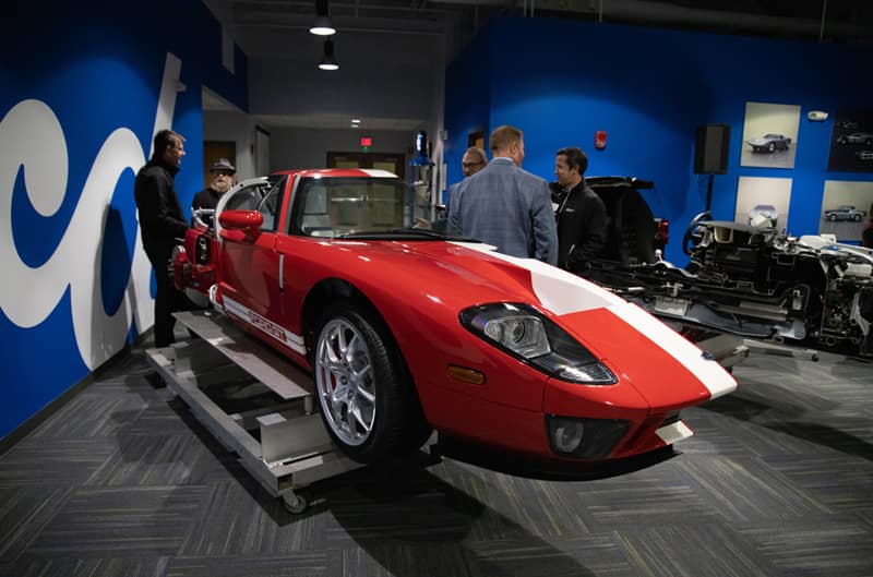 Half of a red GT with white stripes on display