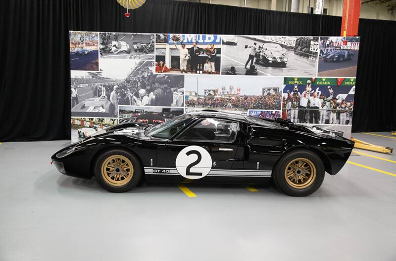 Profile of a black GT on display in front of picture back drop