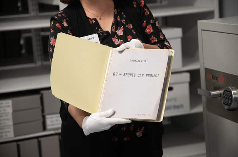 Woman holding up a file for the GT and Sports Car Project