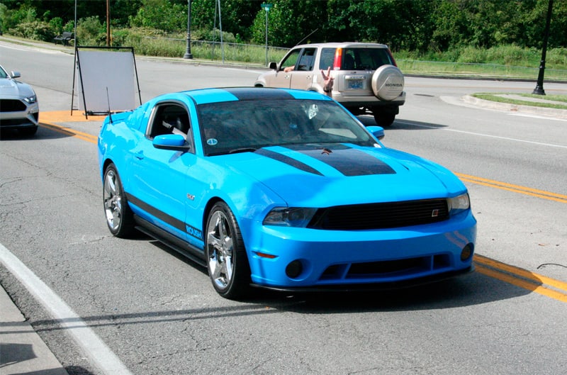 A front side view of a blue Mustang