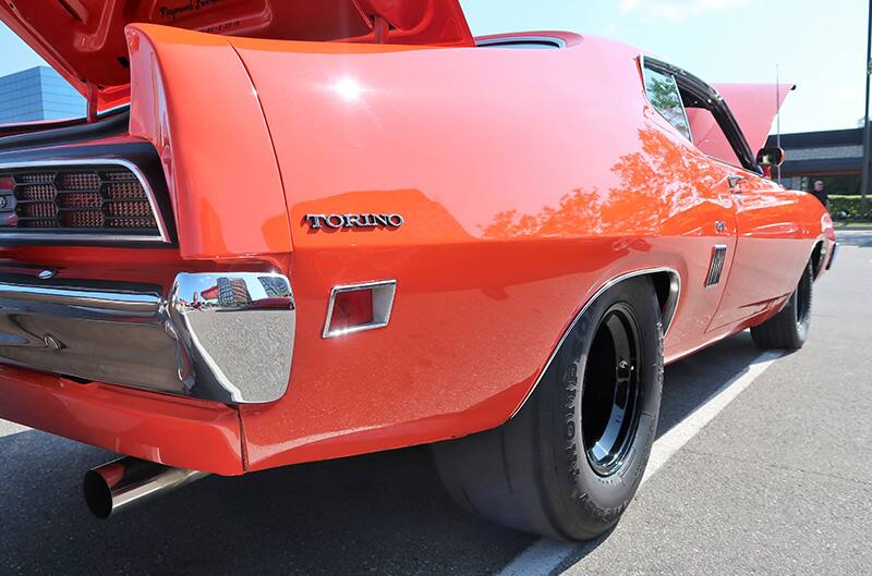 A closeup of the rear side of a red Torino