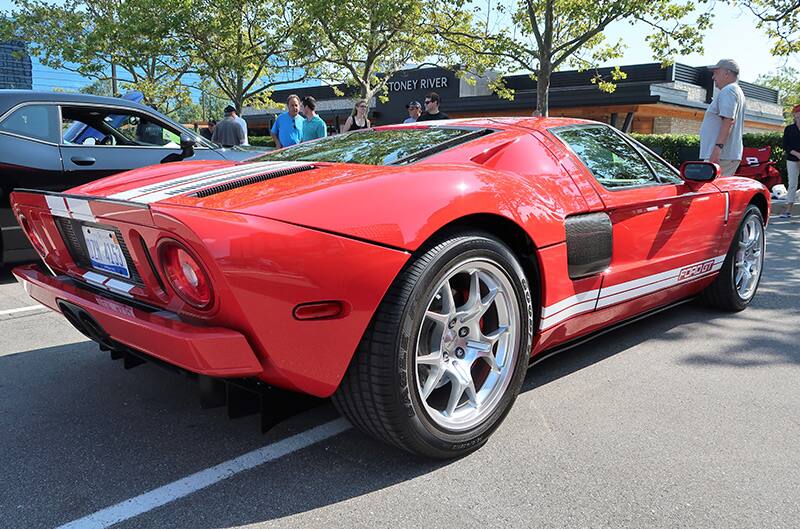 A rear side photo of a red Ford GT