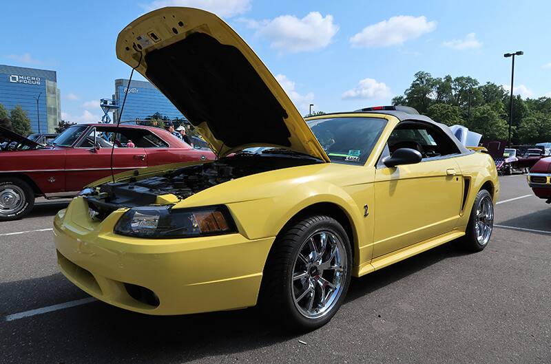 A yellow Mustang convertible on display