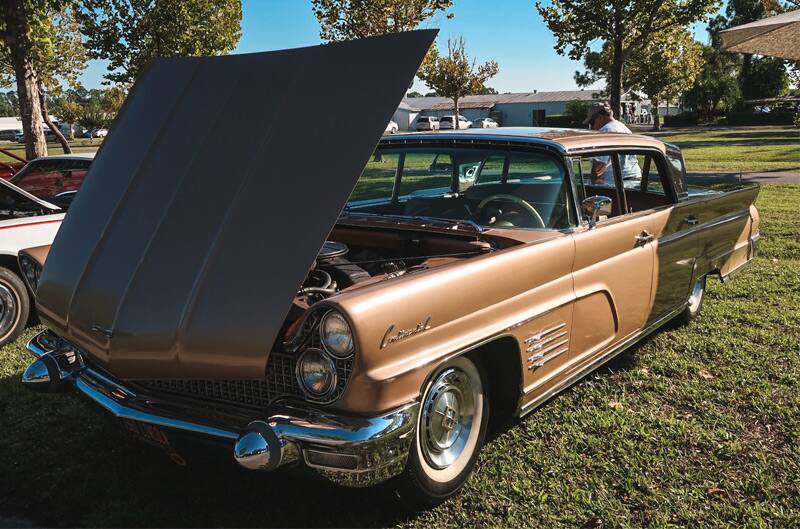 Front of a brown Comet with hood open on the grass