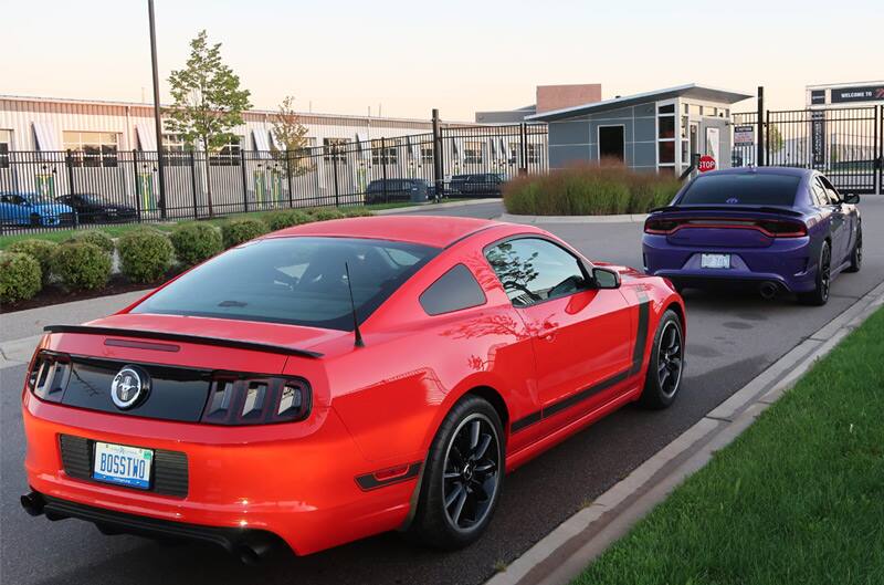 Rear profile of red Mustang parked in lot