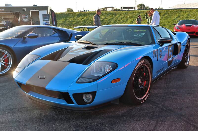 Front of a blue GT with black stripes in parking lot