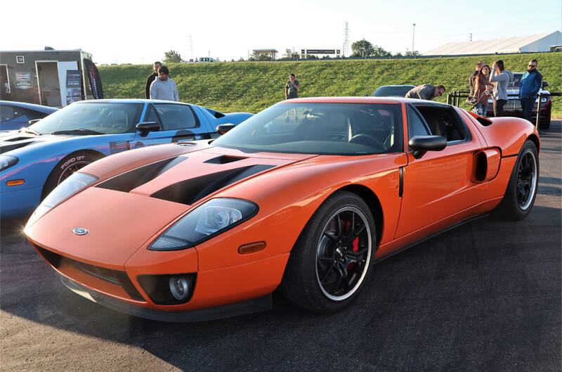 Front profile of an orange GT in parking lot