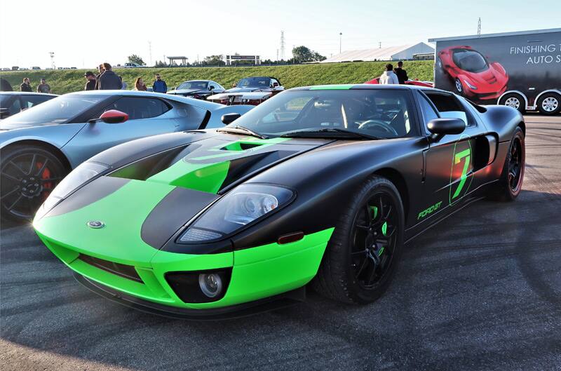 Front of a black and lime green GT in parking lot