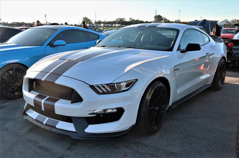 Front of a gray Shelby Mustang with black stripes in the parking lot