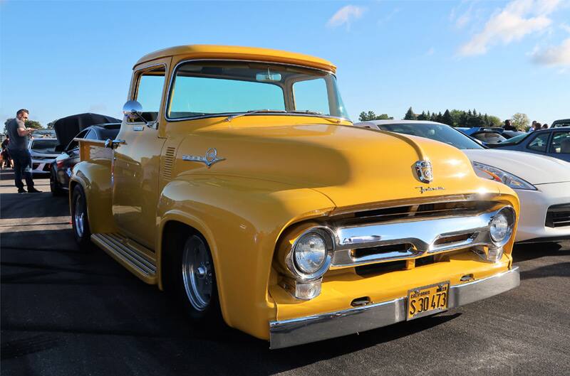 Front of a yellow Ford pickup truck in the parking lot