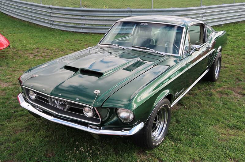 Front of a green Mustang parked on grass