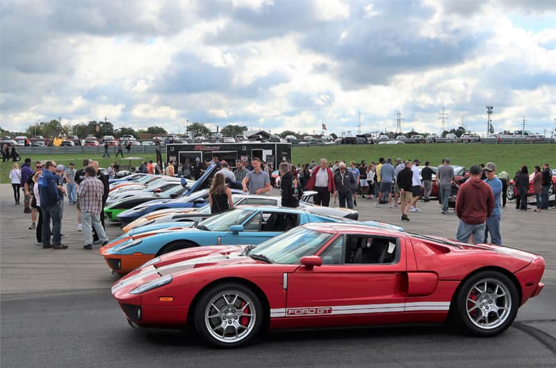 Parking lot full of various Ford Gts