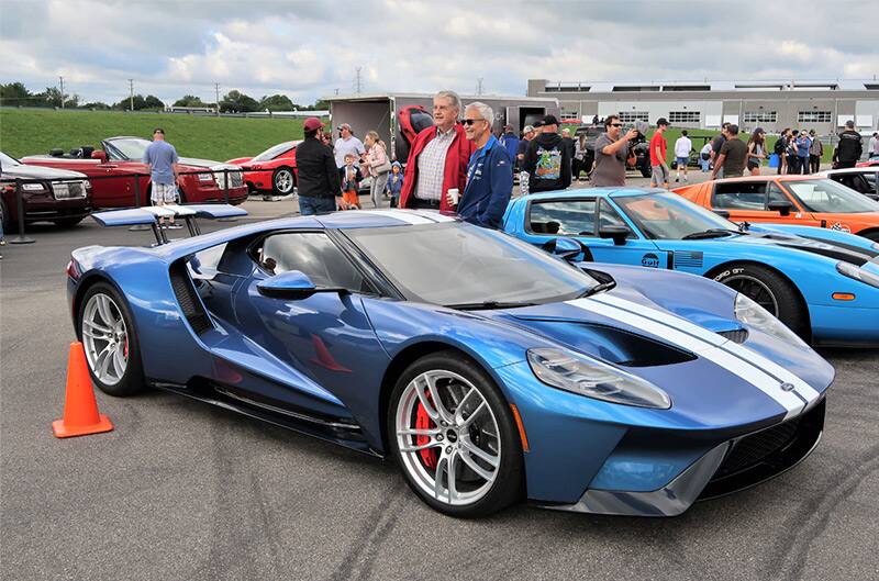 Profile of a blue GT with white stripes in the parking lot