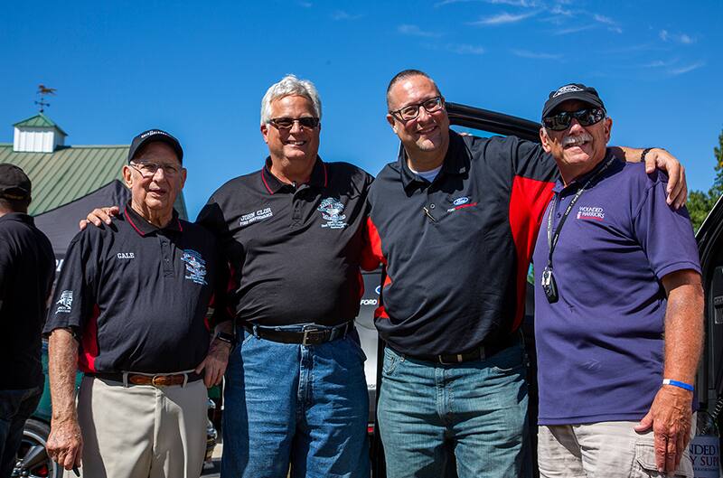 Group of men posing for picture