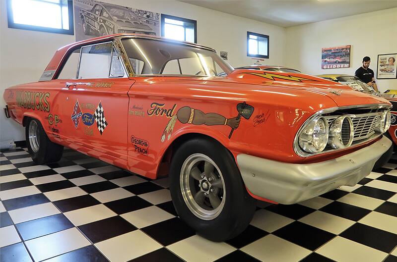 Front profile of a red Cyclone in a garage