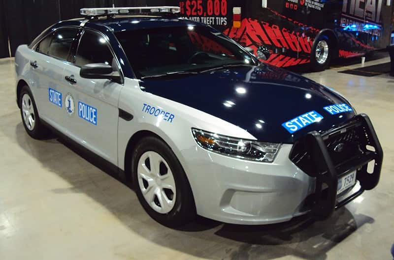 Front of a navy blue and gray state police car