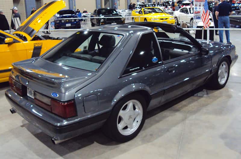 Rear profile of a gray Mustang on display