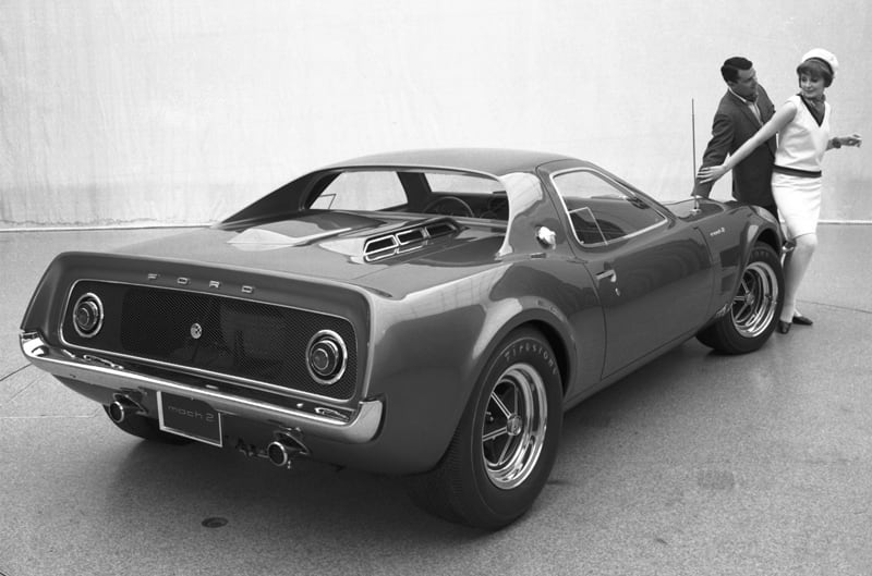 A man and a woman admiring a Mach 2