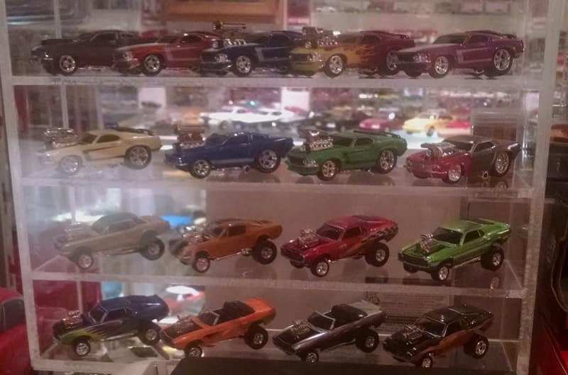 Display case of various toy Ford cars