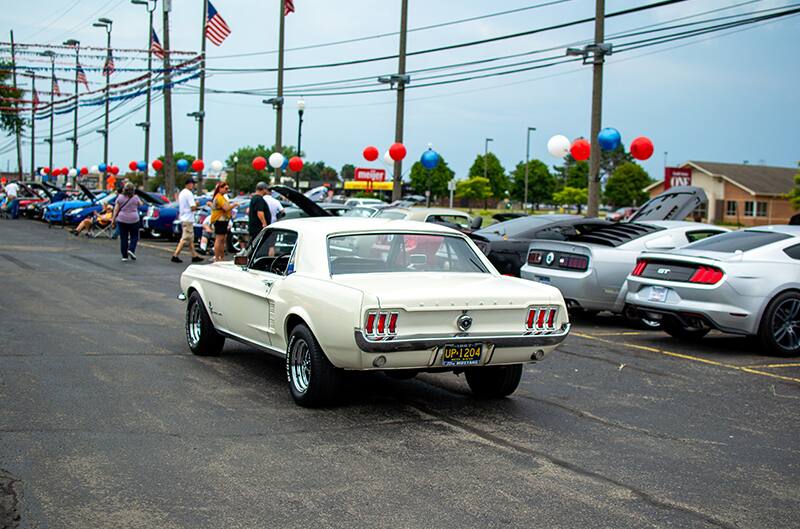 1966 mustang in white cruising in