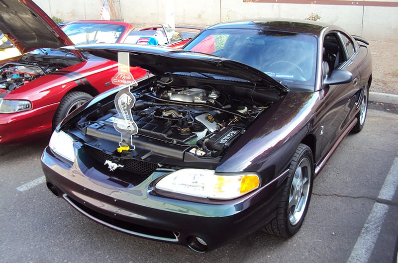 Black SN95 Mustang with hood propped