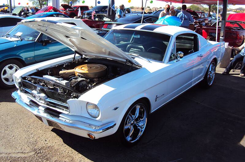 White first generation Mustang with hood open