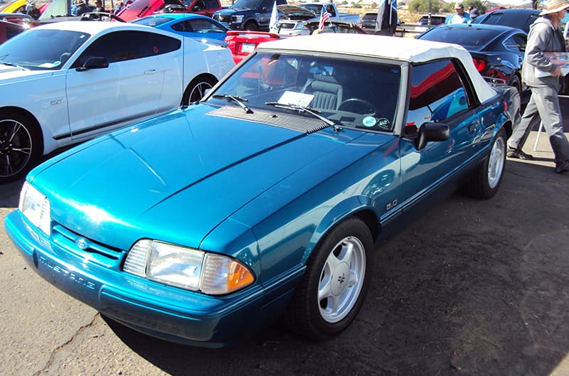 Teal third generation mustang convertible with white top